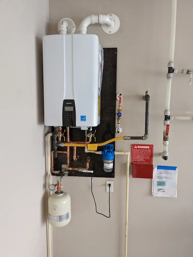 Professional plumber installing copper piping in a Conneaut home